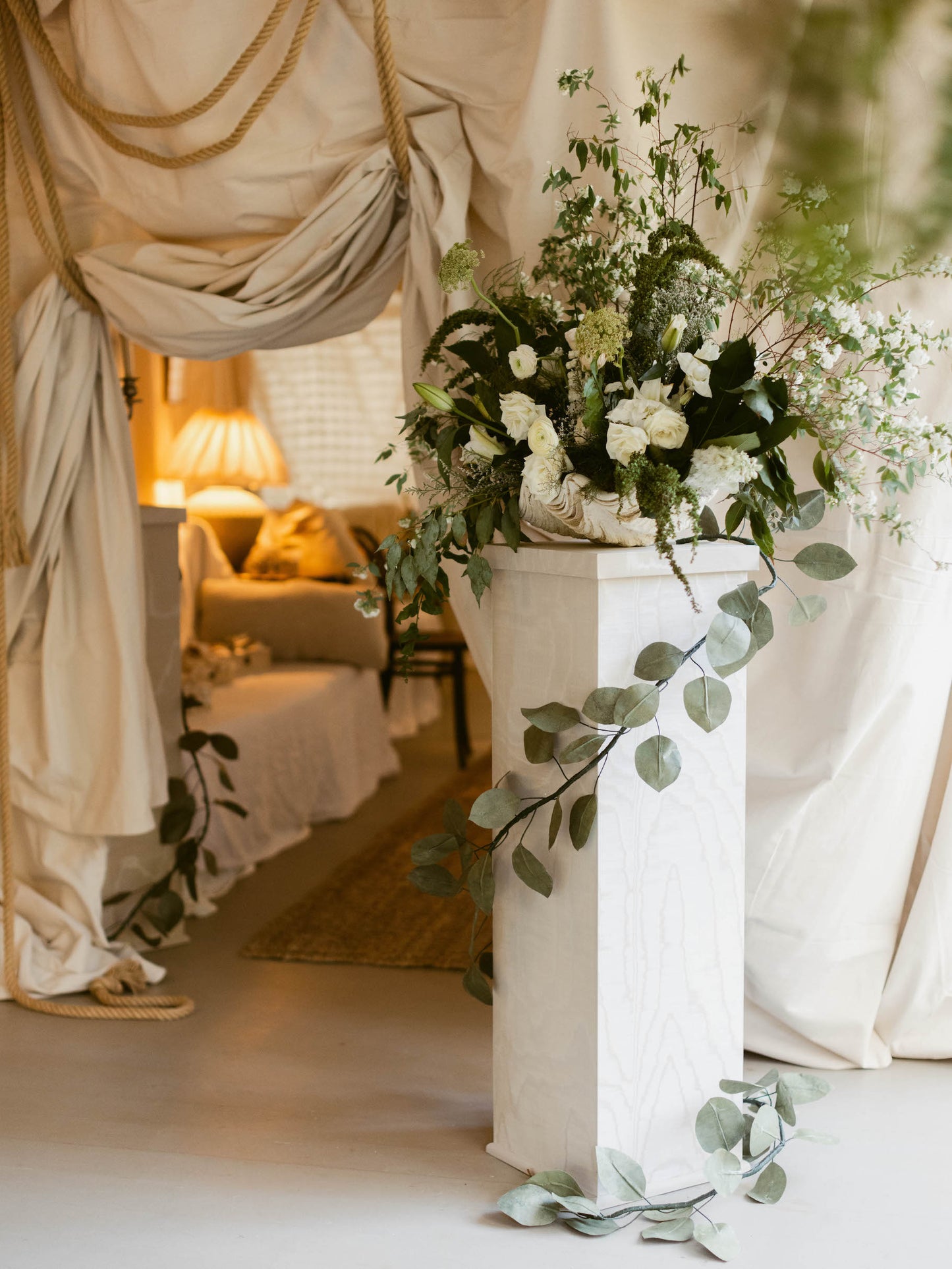 Elegant handmade moiré pedestal with floral arrangement in refined home setting