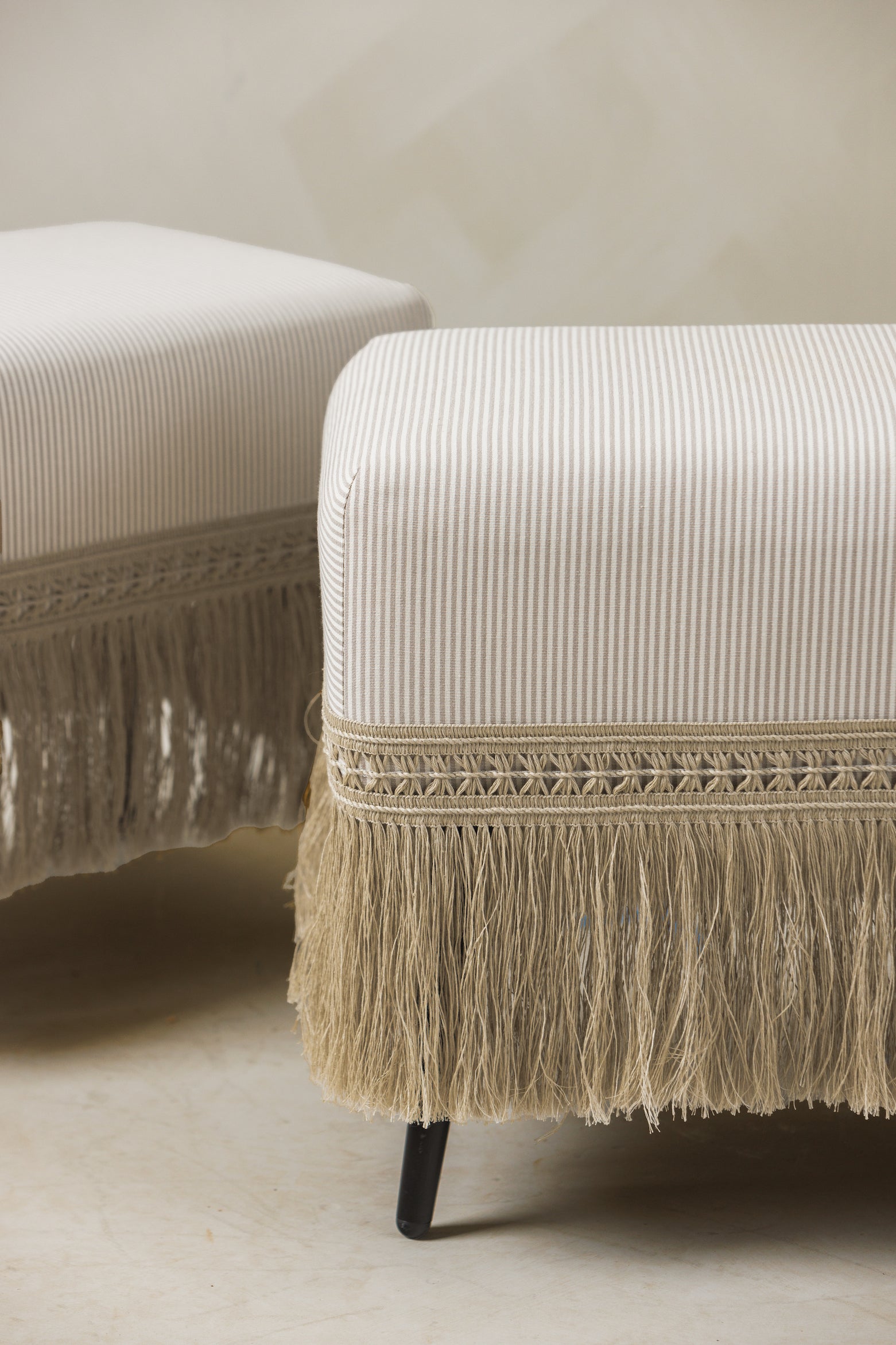 Close-up of pinstripe raffia-trim stools from The Naturalist Set by Page House Studio