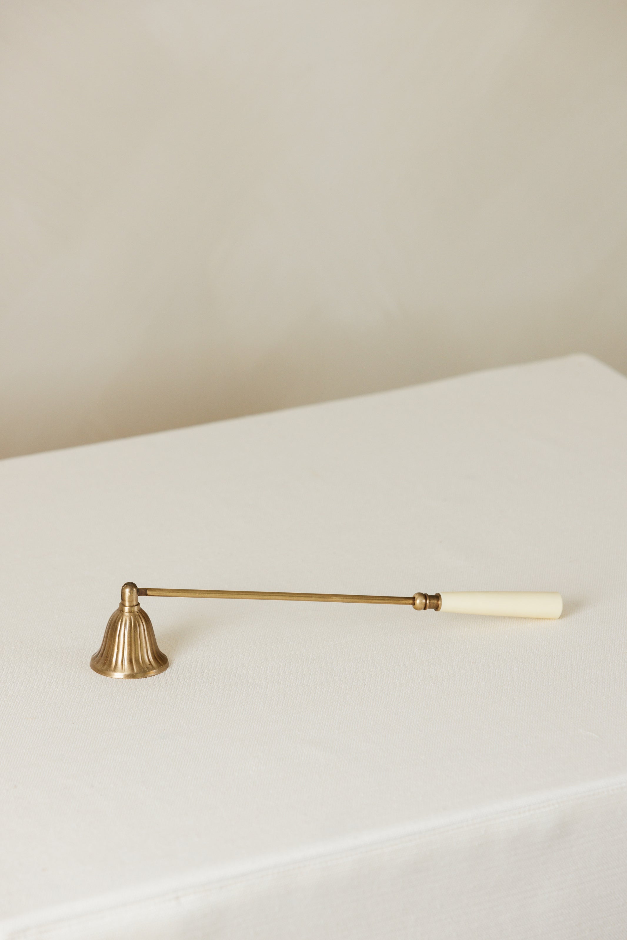 Elegant brass and bone candle snuffer – Page House Studio