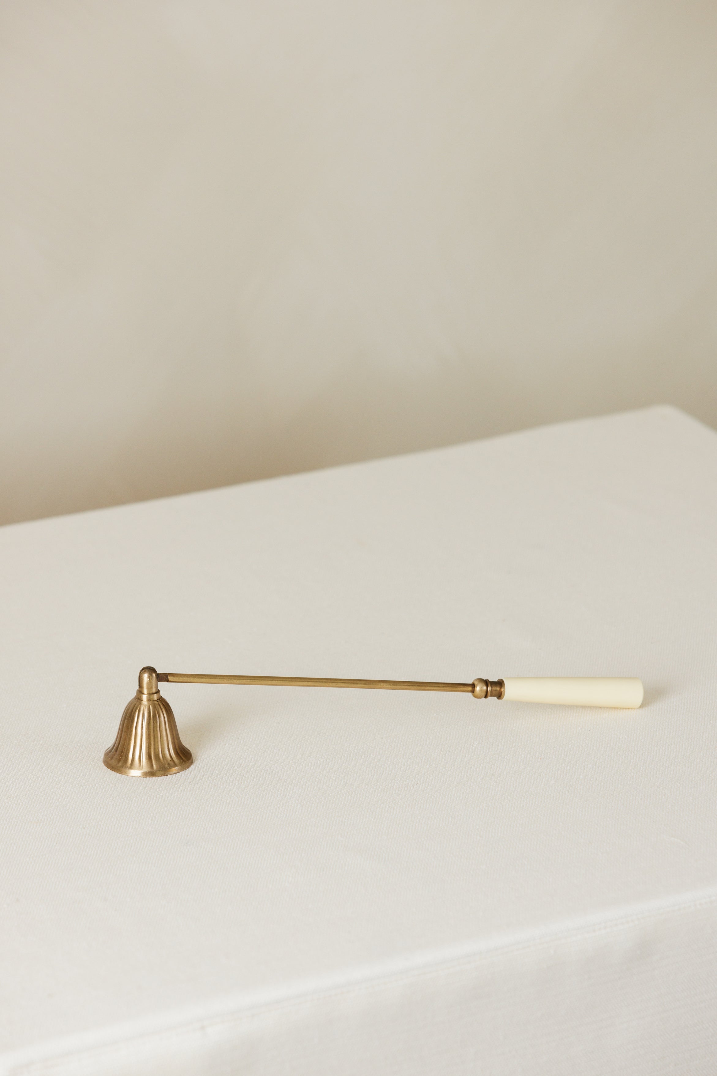 Elegant brass and bone candle snuffer – Page House Studio