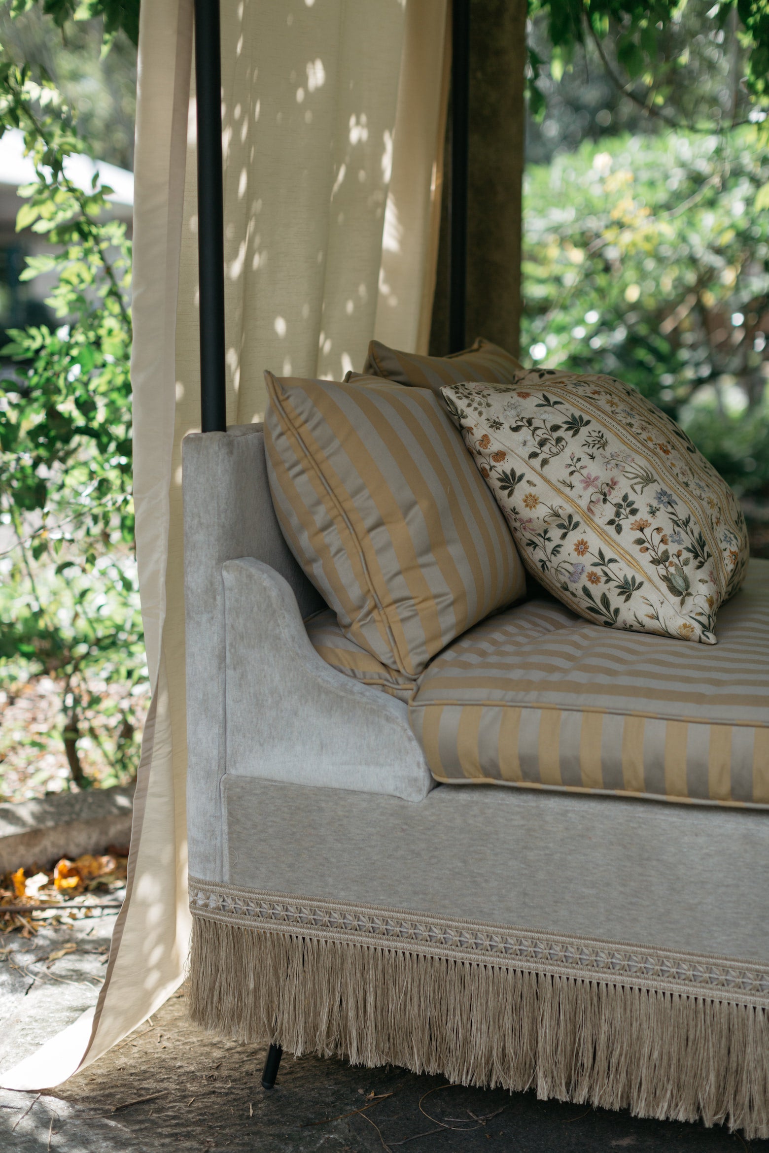 Serenbe Daybed on garden terrace with mix of pillows including Botanico print – Page House Studio