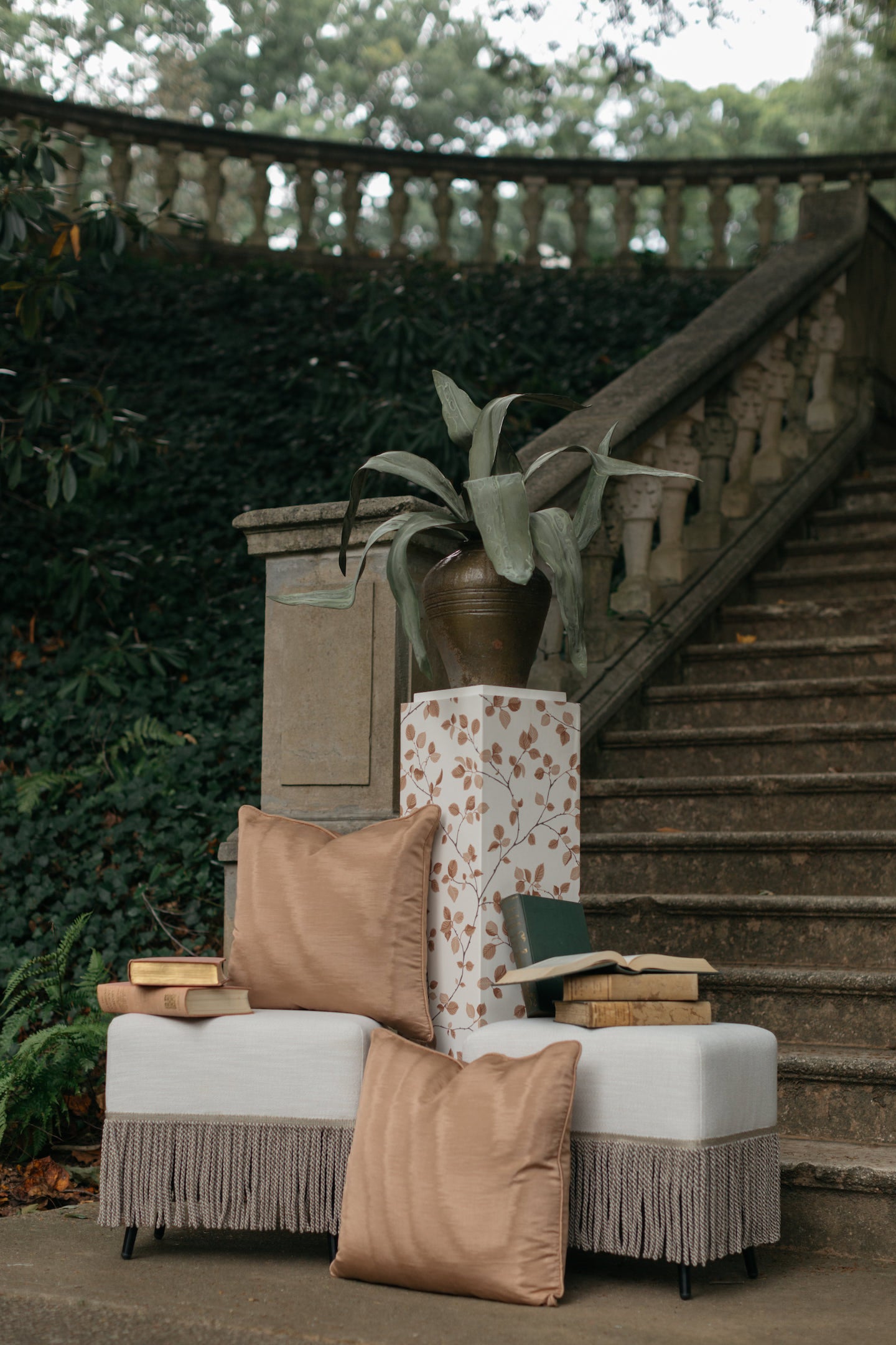 Outdoor garden styling with Moire Pillows, Sofia stools, faux aloe plant, and Vine pedestal on stone steps – Page House Studio