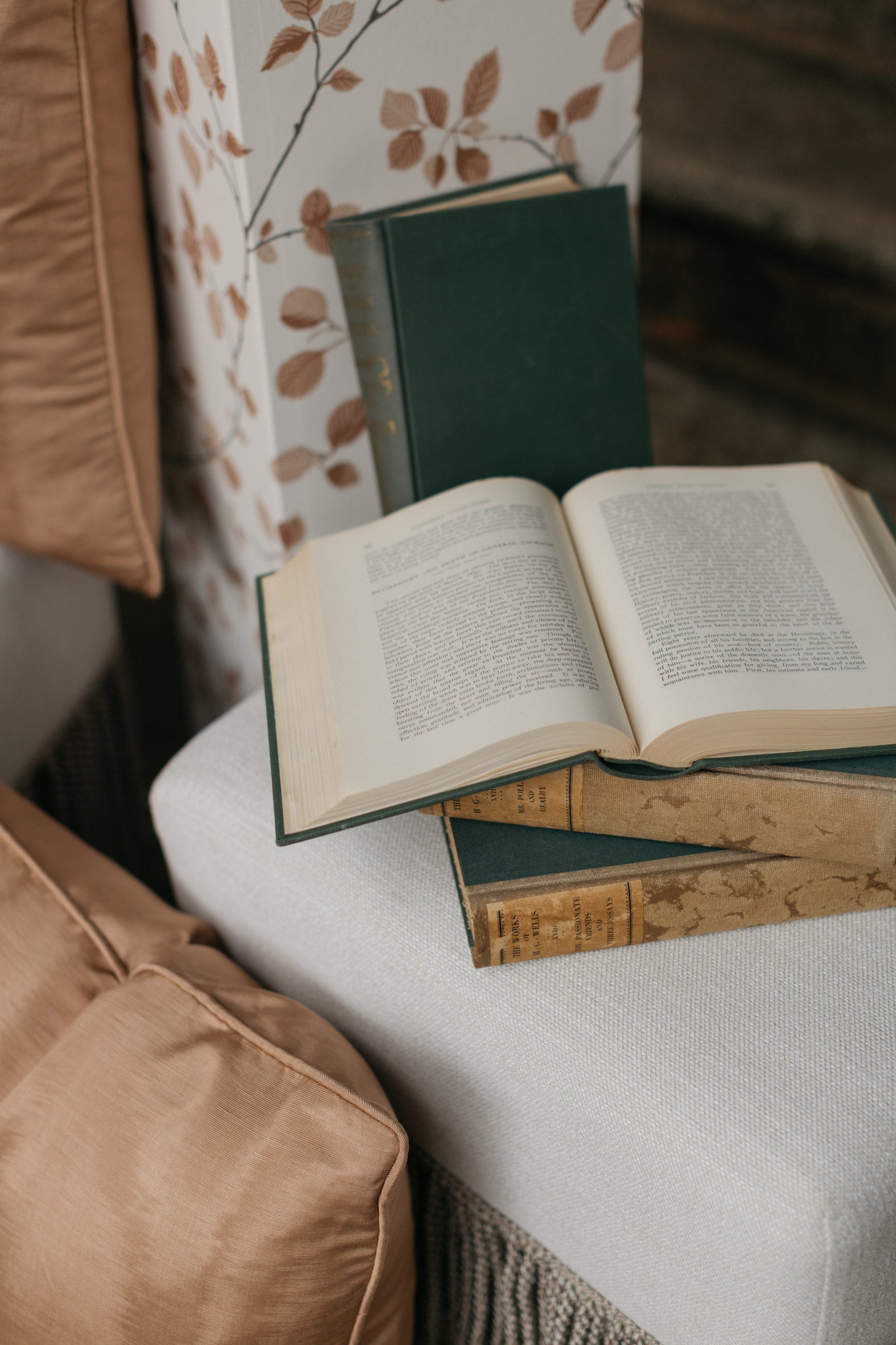 Side view of Moire Pillow with decor books and pedestal in outdoor setting – Page House Studio